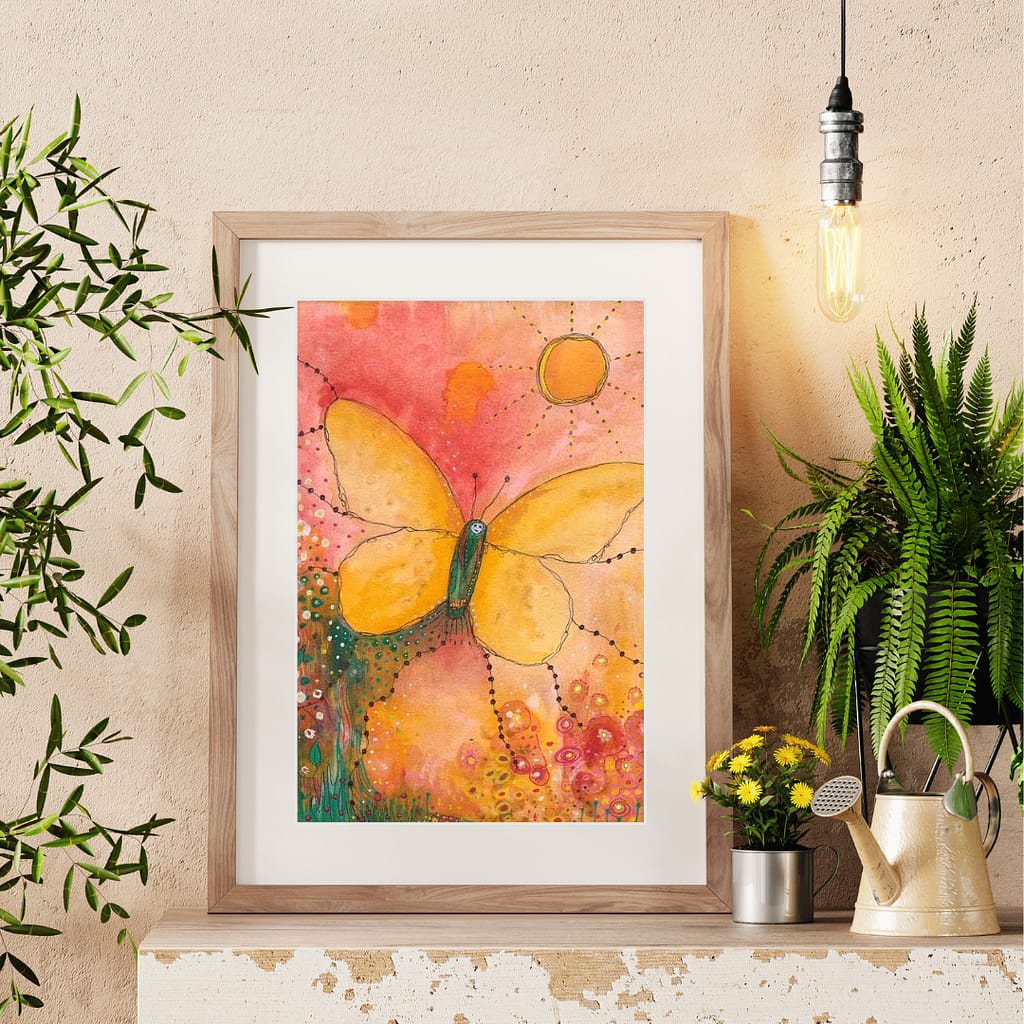 Butterfly art print framed and in context. Image of butterfly uses soft tones of yellows and oranges and the butterfly is rising to greet the sun